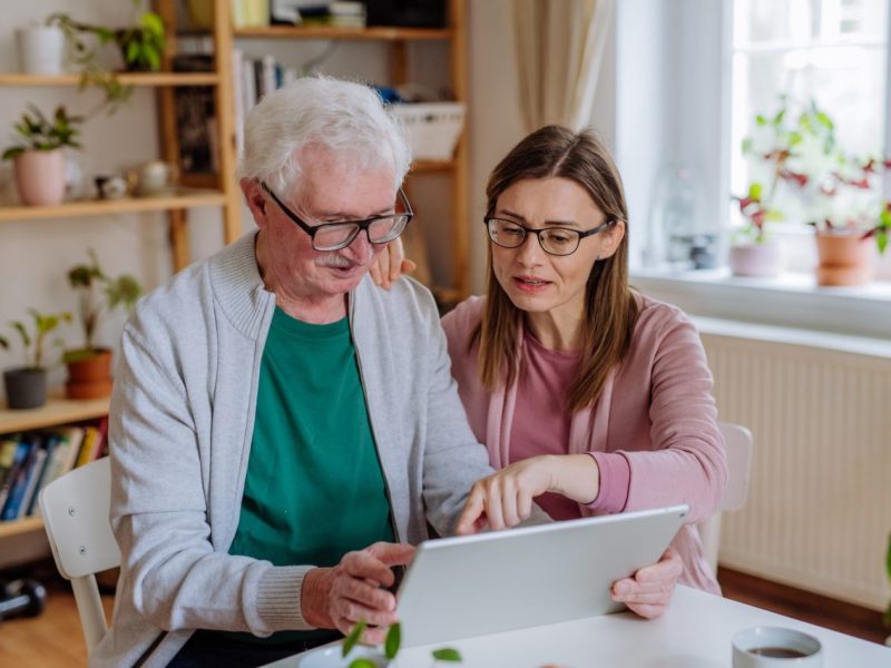 adult-daughter-visiting-her-senior-father-at-home-and-using-tablet-.jpg adult-daughter-visiting-her-senior-father-at-home-and-using-tablet-.jpg